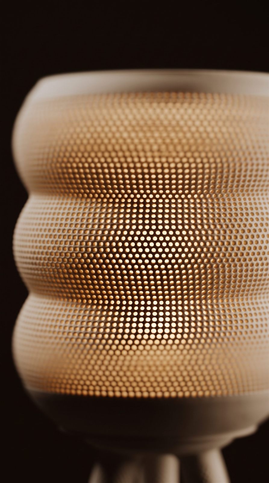Close-up of a perforated shade glowing